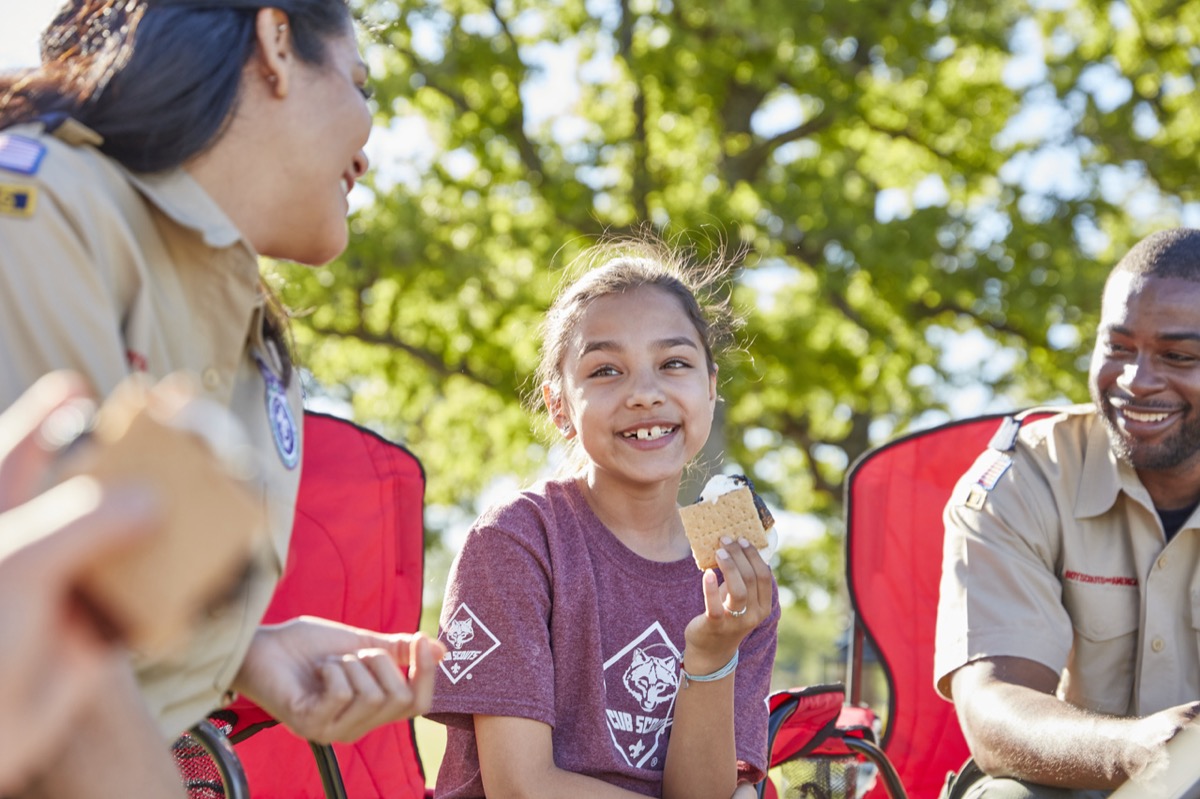 A Cub Scout and leader sharing a campfire moment