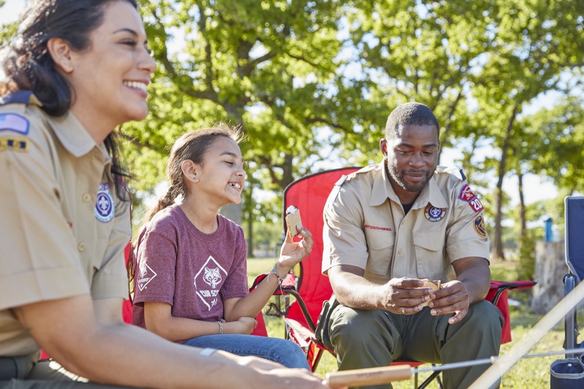 Den leaders chatting with a Cub Scout